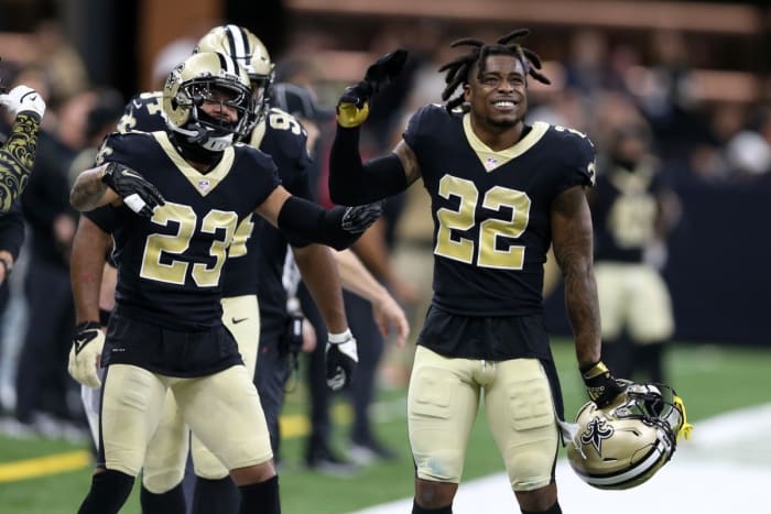 New Orleans Saints defensive backs Marshon Lattimore (23) and New Orleans Saints Chauncey Gardner-Johnson (22) celebrate against the Carolina Panthers. Mandatory Credit: Chuck Cook-USA TODAY